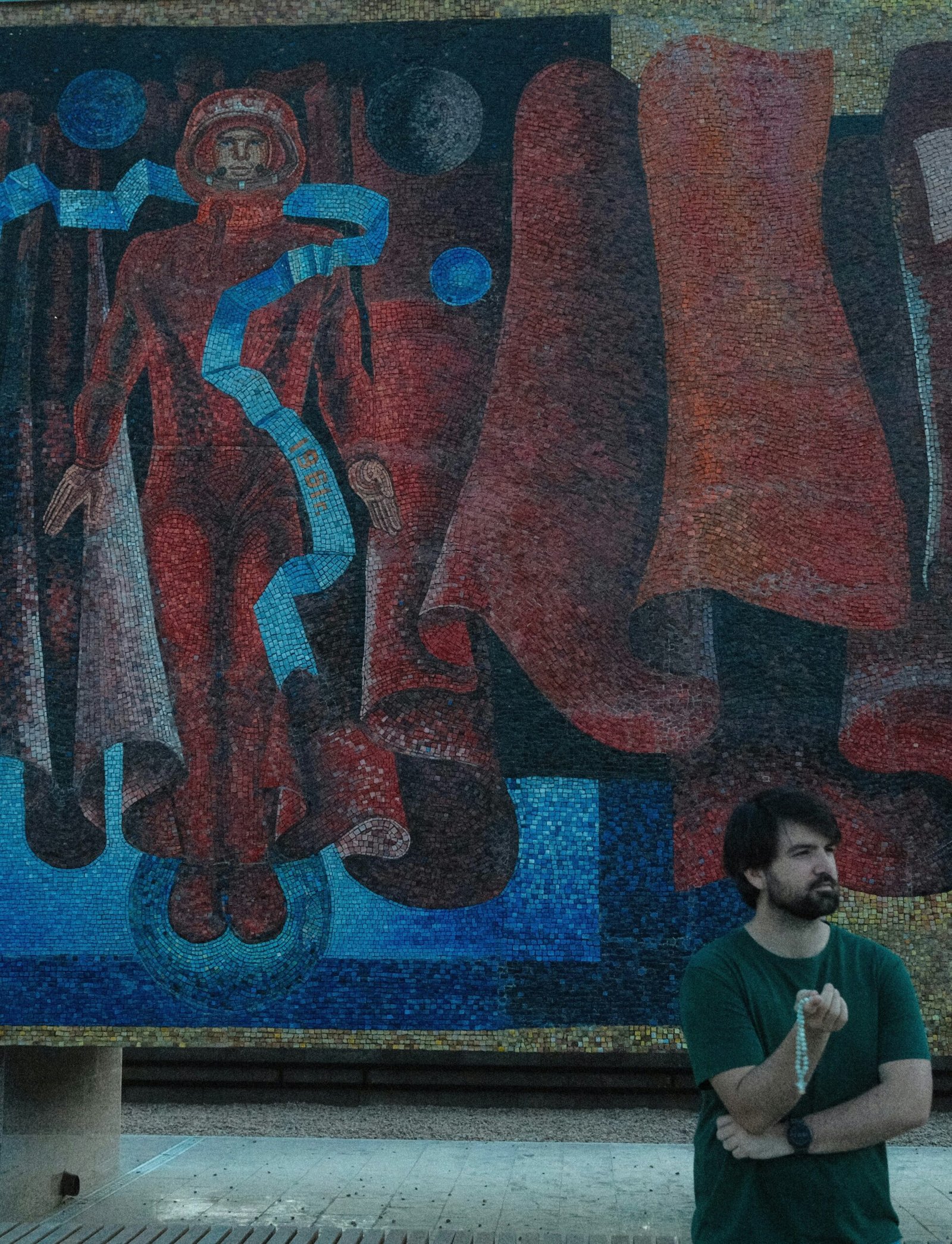 A man standing in front of a large painting